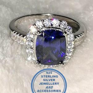 "925 sterling Silver Ring with Large Blue Rectangular cubic with clear cubics all around and going down on sides of this ring"