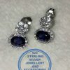 "925 sterling Silver Dangle Stud Earrings with oval Blue bottom on a clear stud surrounded by clear cubics "