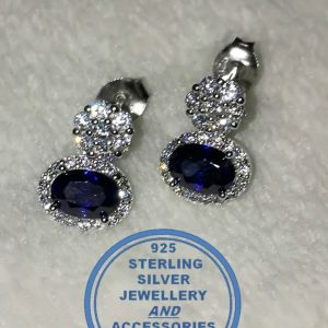 "925 sterling Silver Dangle Stud Earrings with oval Blue bottom on a clear stud surrounded by clear cubics "