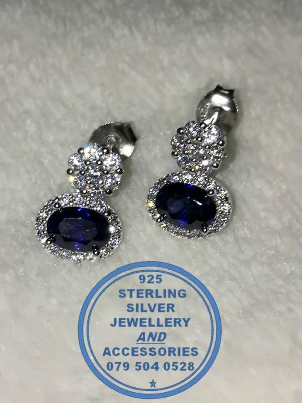 "925 sterling Silver Dangle Stud Earrings with oval Blue bottom on a clear stud surrounded by clear cubics "