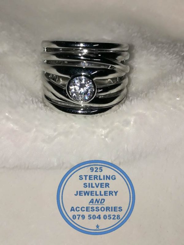 "925 Sterling Silver Broad Ring with detail of 7 bands as 1 with large round cubic stone in tubular setting. Statement Ring."